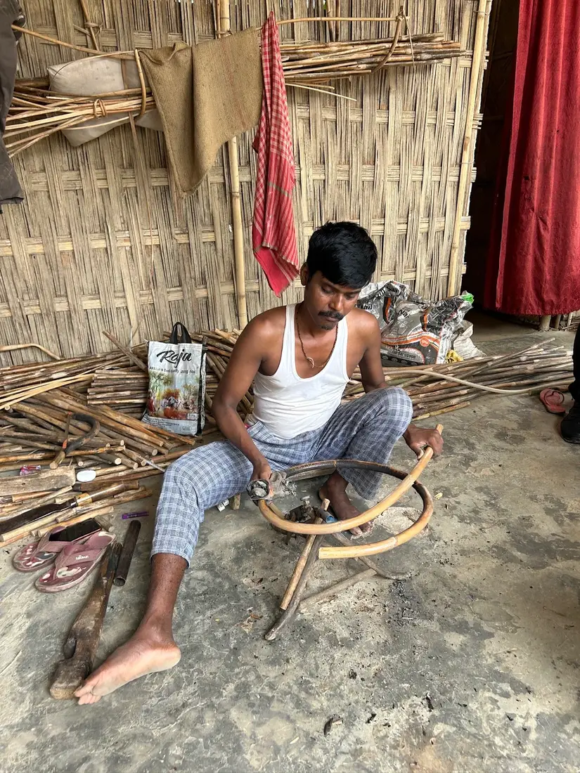 A craftsperson weaving by hand